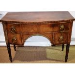 A Regency faded mahogany veneered bow fronted dressing table, the long drawer above an arcaded