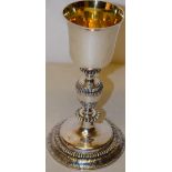 An eighteenth century French silver chalice, the bell shape bowl gilded inside, on a ribbed baluster