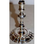 A George II cast silver taperstick, the spool shape holder on a moulded facetted knopped silesian