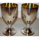 A pair of George III silver wine goblets, the bowls gilded inside, on a circular stem foot with