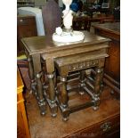 A Nest of three dark Oak occasional Tables having turned legs and perimeter stretchers.