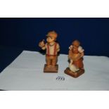 Two wooden German Hummel style figures - a girl with a goose and a boy with a bird on his hand a/f