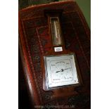 A wooden Barometer and thermometer made in England