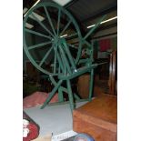 A green painted Spinning wheel.
