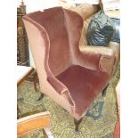 A brown Dralon upholstered wing Fireside Armchair of classic Georgian design standing on cabriole