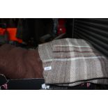 A brown Wool Blanket and a tartan travel rug.