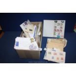 A box of stamps divided into individual envelopes of stamps including Isle of Man, Spain, Portugal,