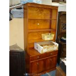 A Yew wood finished contemporary Bookshelves on Cupboard having a base with two drawers and two