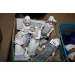 A Lladro figure of a young fisherman, a boy carrying water buckets and a girl with a lamb, all a/f,