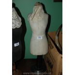 An antique miniature dress mannequin, cream.