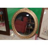 An oval gilt trimmed Mirror decorated with ivy leaves.