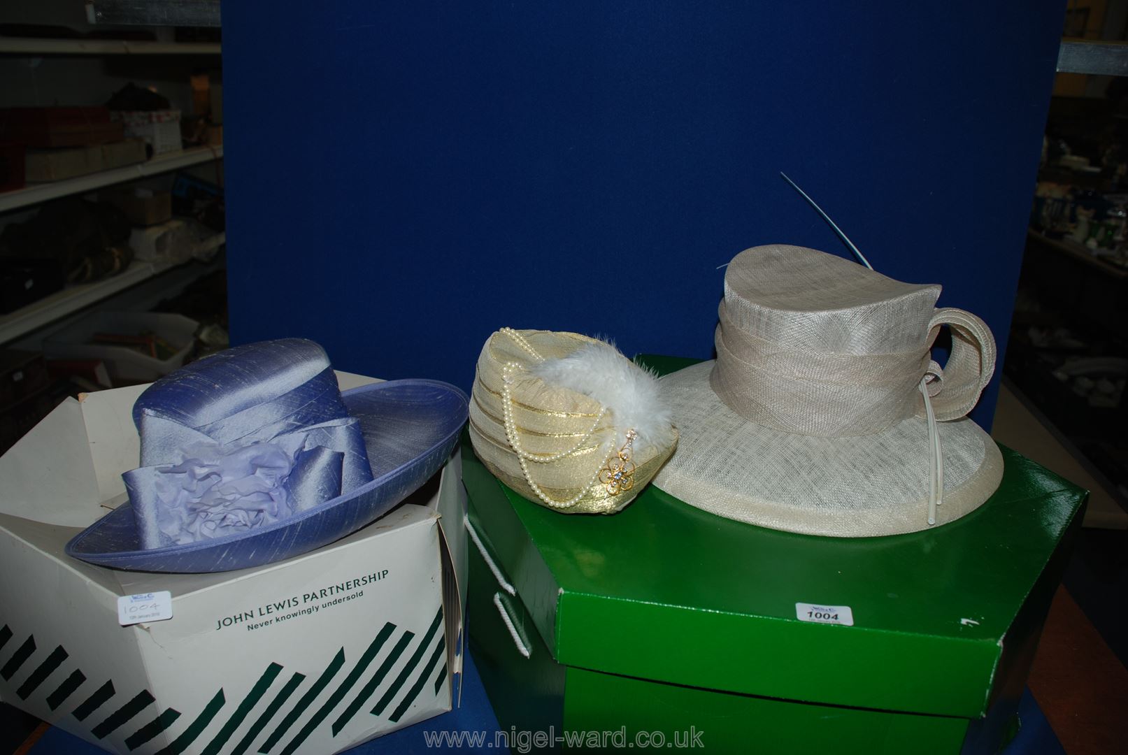 Three wedding hats in hat boxes