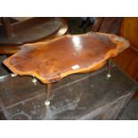 A Yew wood rustic tree-trunk slice Coffee Table. 33 3/4'' x 15'' x 10 1/2'' high.