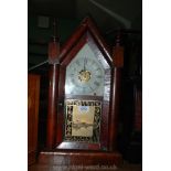 A restored American wall Clock with a sharp Gothic case.