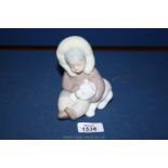 A Lladro figure of an Inuit Eskimo child with Bear.