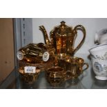 A Wade gold lustre coffee set including six cups, six saucers, coffee pot,