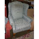 A very elegant Georgian style wing fireside armchair having duo-tone shadow fern green upholstery