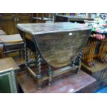 An Oak gate-leg drop-leaf Dining Table having twist legs,