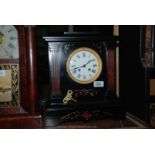 A black Victorian slate Clock, French movement, chimes on the hour and half-hour.