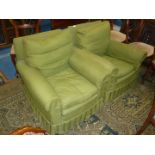 A pair of green loose covered fireside Armchairs complete with arm protectors.