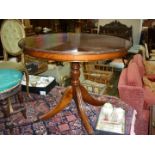 A reproduction cross-banded topped Mahogany snap-top Table having a turned pillar and four splay