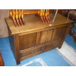 A contemporary Oak Blanket Chest with linen fold detail central panel and with a pair of short
