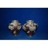 A pair of Tibetan copper temple Vases with applied decoration.