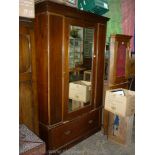 A circa 1930 Mahogany wardrobe having a large mirrored central door,