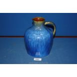 A signed Denby vase in blue mottled colour,