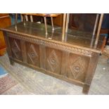 A four panel Oak Blanket Chest/Coffer having diamond shape and stylised flower bloom detail to the