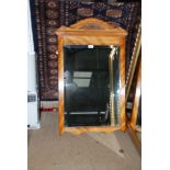 An antique bevelled hall Mirror with wooden frame.