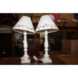 A pair of cream porcelain Table Lamps with cream and floral pattern shades, 20'' tall.