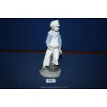 A Lladro figure of Boy with Yacht, designed by Salvador Furio.