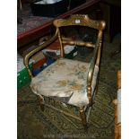 A gold painted framed open armed Chair having ridged turned front legs and stretcher.