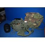 An Army combat belt and camouflage bag.