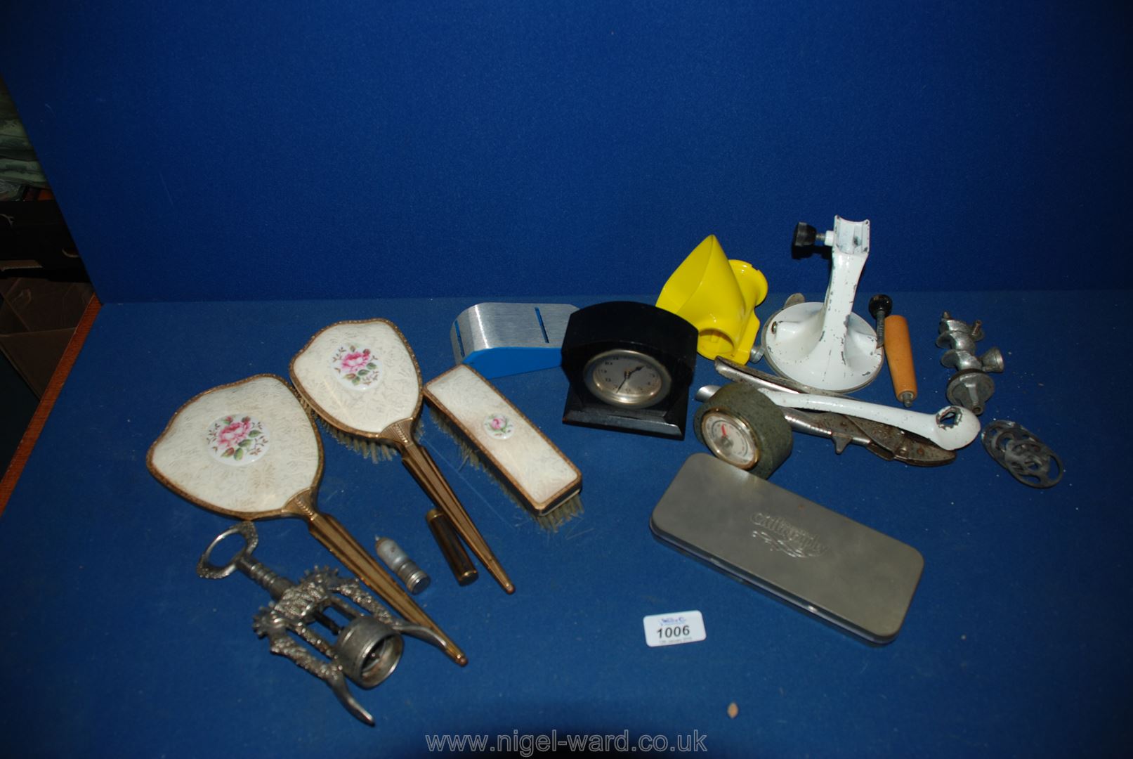 A box of miscellanea including dressing table set, small wooden clock, some calligraphy nibs,