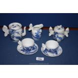 A blue and white Japanese porcelain tea for two set with butterfly detail,