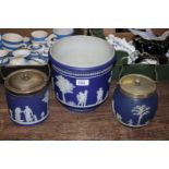 A large Wedgwood dark blue jasper ware jardiniere (a/f) and two biscuit barrels.