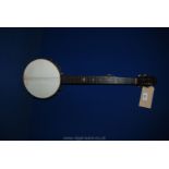 An old five string open back Banjo with detailed inlaid banding inside drum.