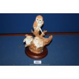 A Worcester Ornamental Studio hand crafted and painted model of an Owl and three owlets in a tree.