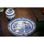 A blue and white willow pattern meat plate and a Booths 'Real Old Willow' ginger jar.
