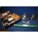 A box of miscellaneous items including playing cards, barometer and clock set in stirrups,