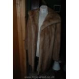 A ladies knee length pale fur Coat