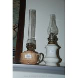 A white pottery based oil lamp and a mottled glass oil lamp.