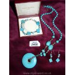 A set of turquoise jewellery including a necklace, a bracelet and earrings.