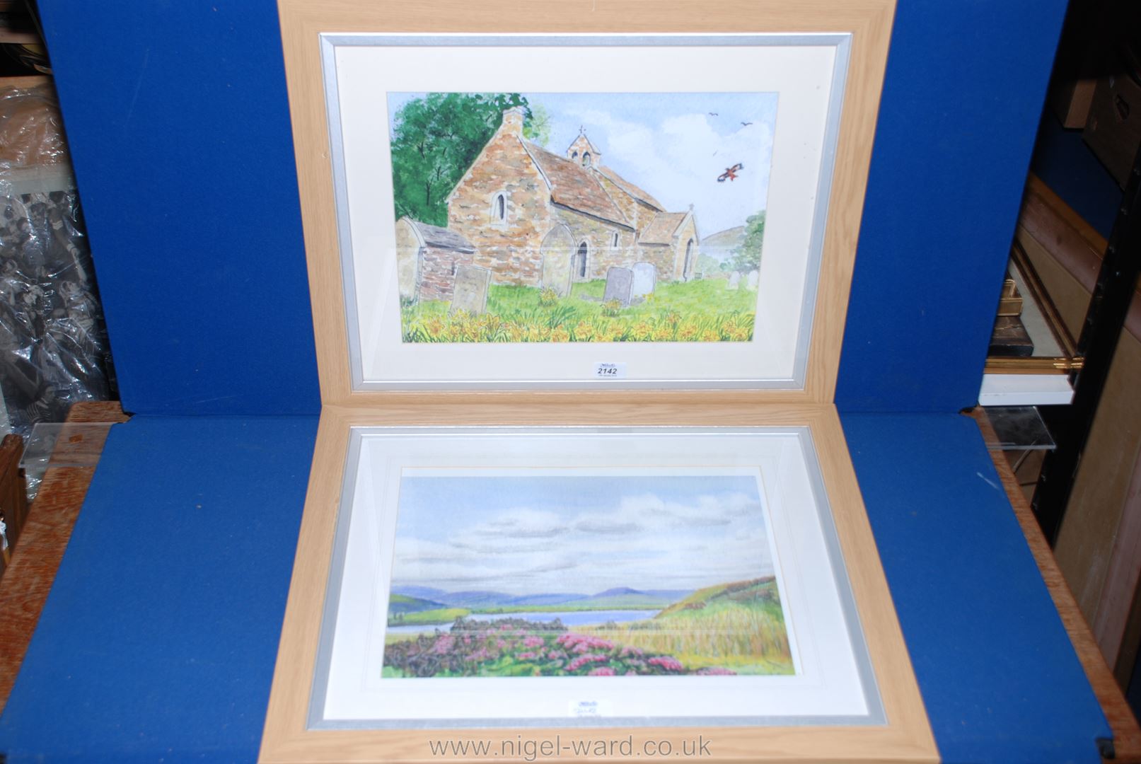 A pair of Prints on canvas, one of a landscape with lake and hills the other,