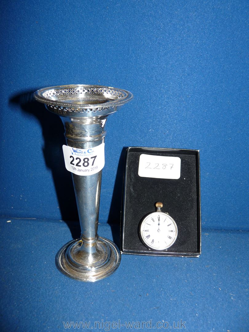 A silver hallmarked trumpet vase and a silver pocket watch with an elegant enamel face.