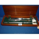 A 1970's stainless steel carving set in teak lidded box