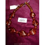 A string of amber coloured beads,