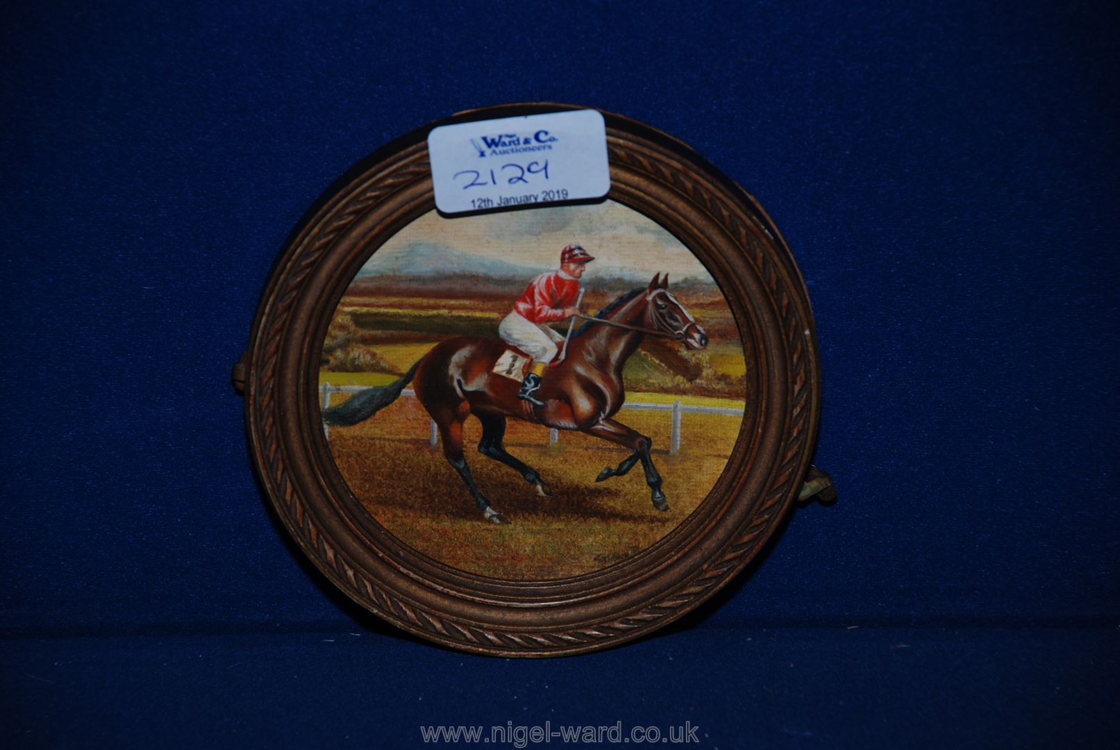 A small circular Oil painting "Horse and Jockey", signed.